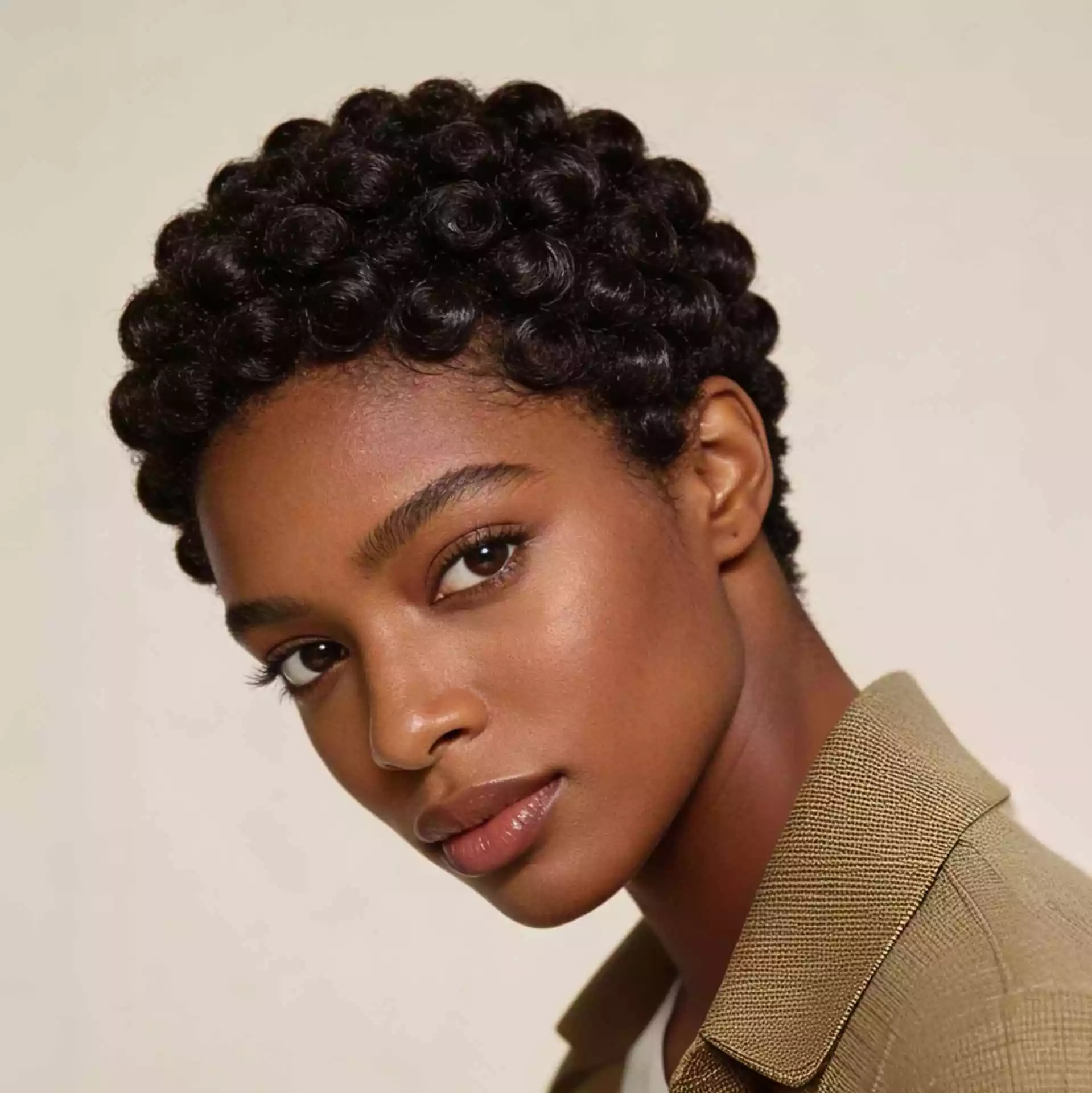 rounded finger coils on short natural hair for black women with compact definition and a soft balanced shape