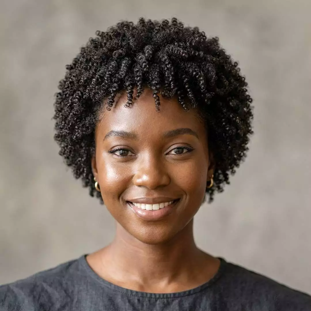 short natural hairstyles for black women hero image with defined coils, compact shape, soft natural volume, and a neat face-framing outline