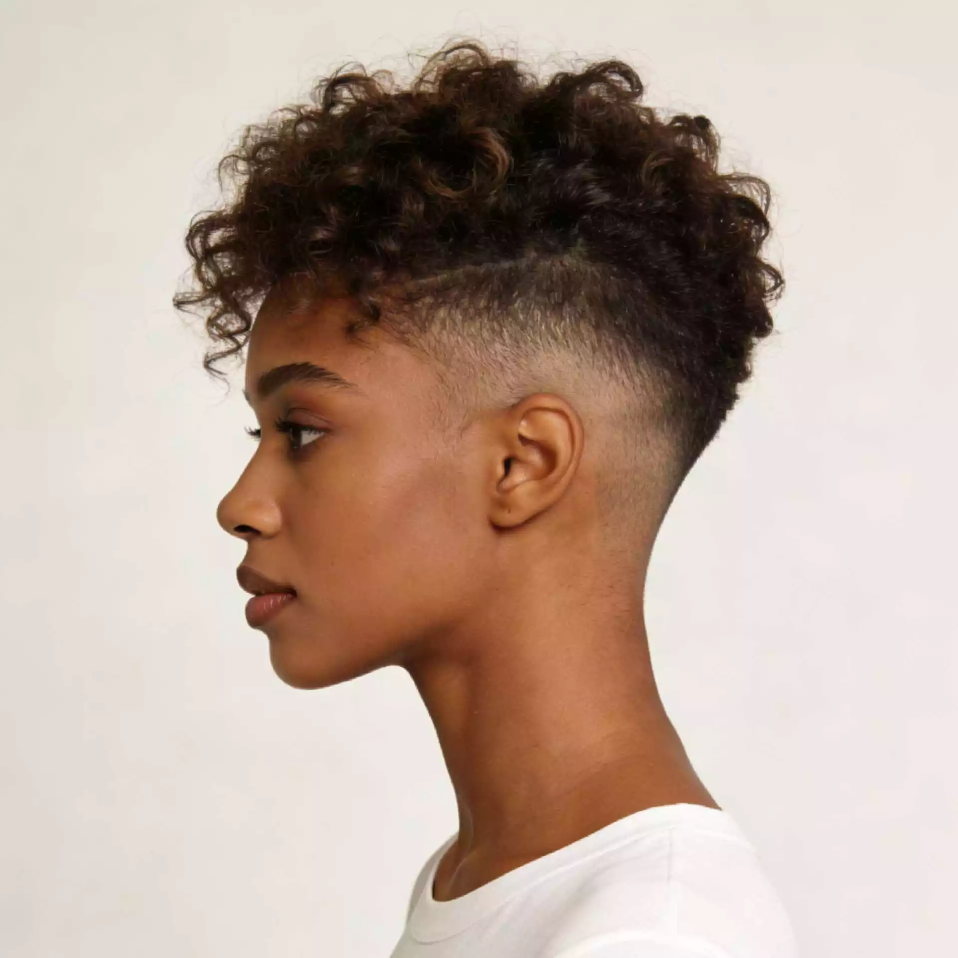 soft curly tapered natural hairstyle for black women with airy top texture and cleaner sides