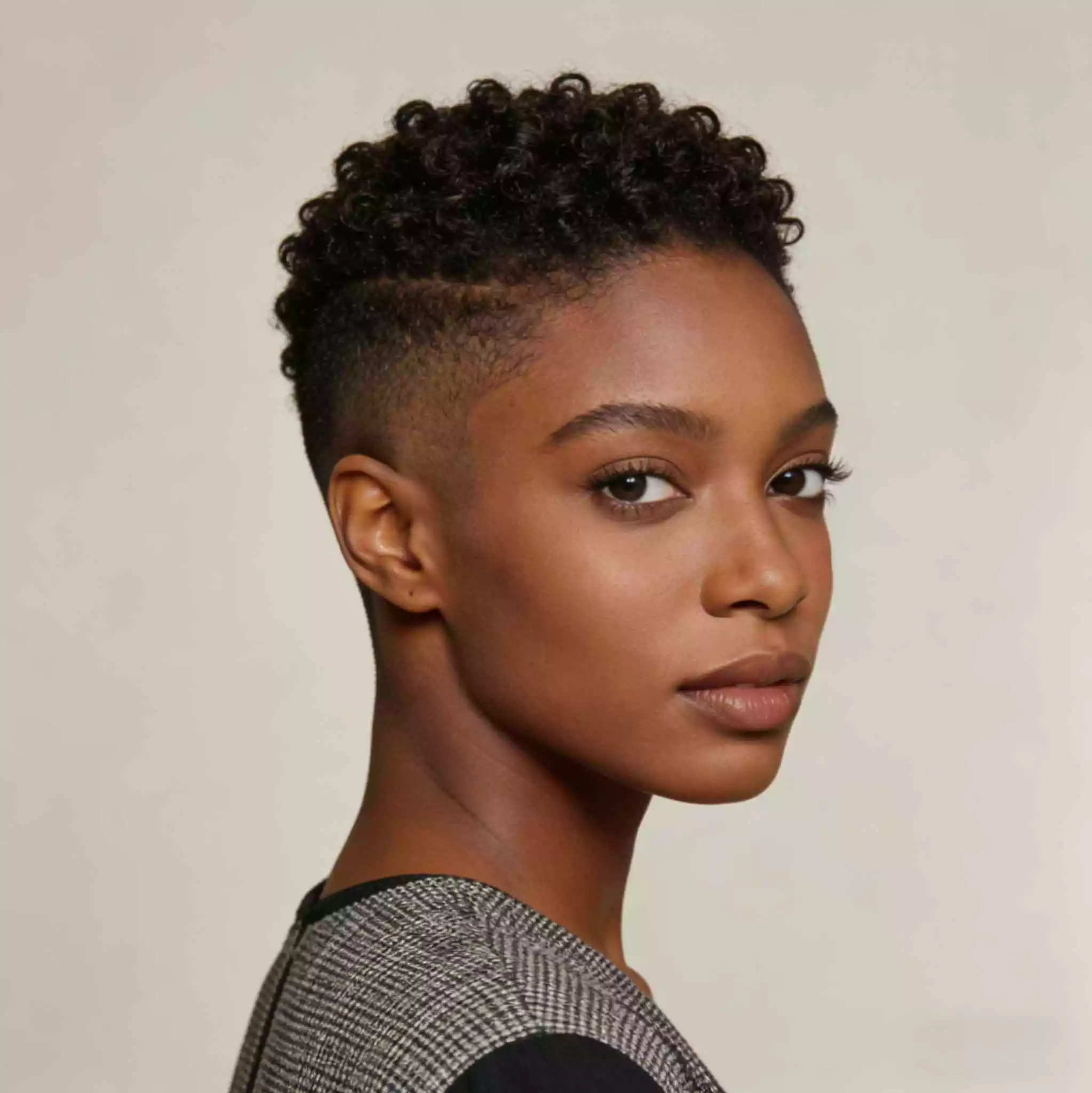 tapered finger coils on short natural hair for black women with defined top coils and a cleaner tapered outline
