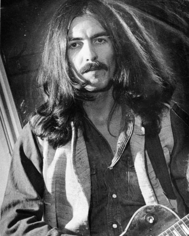 George Harrison classic 1970s long wavy hair with mustache and hippie style