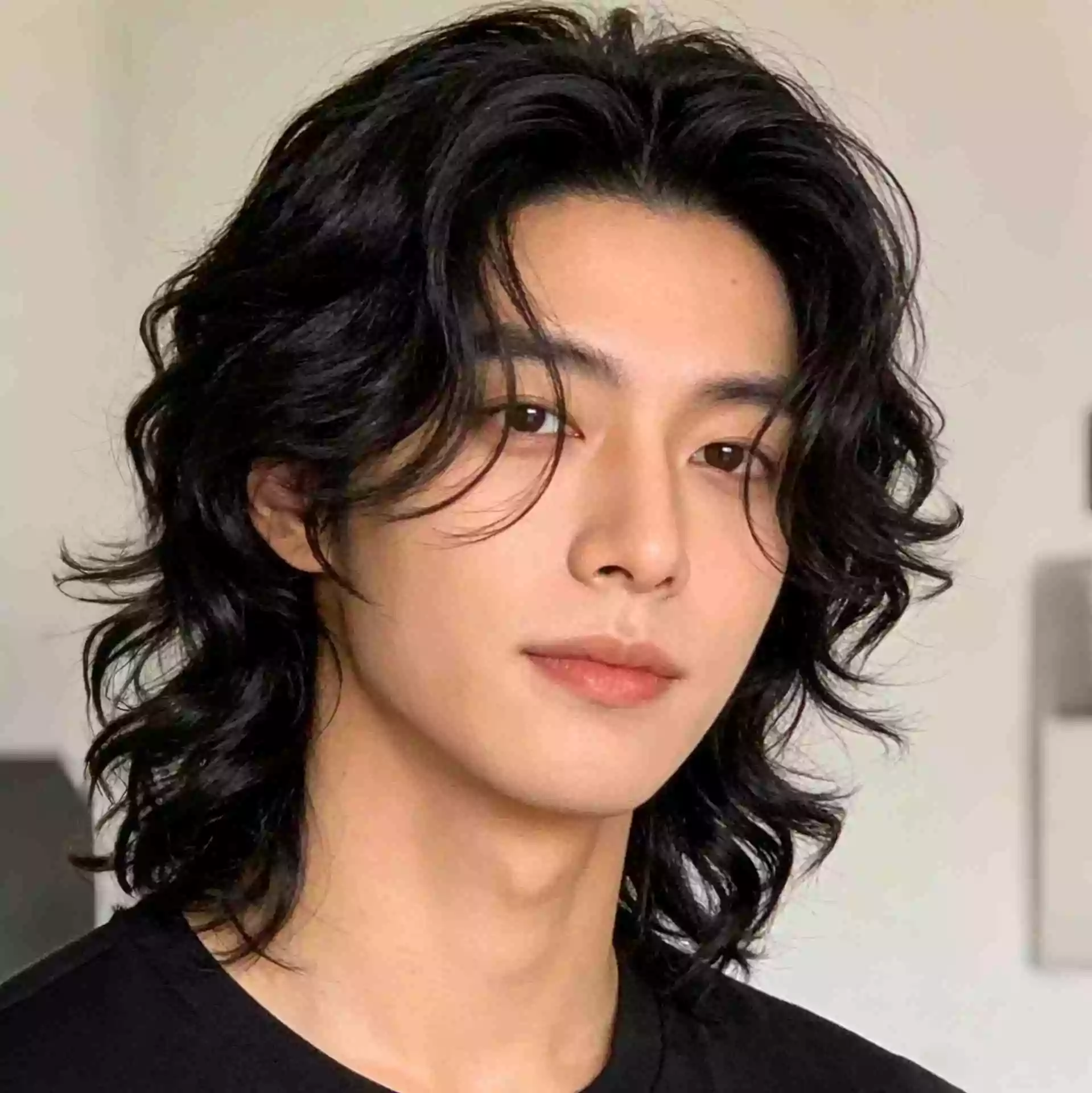 Asian men long wavy hair — loose soft waves with medium-long layered shape, 2026