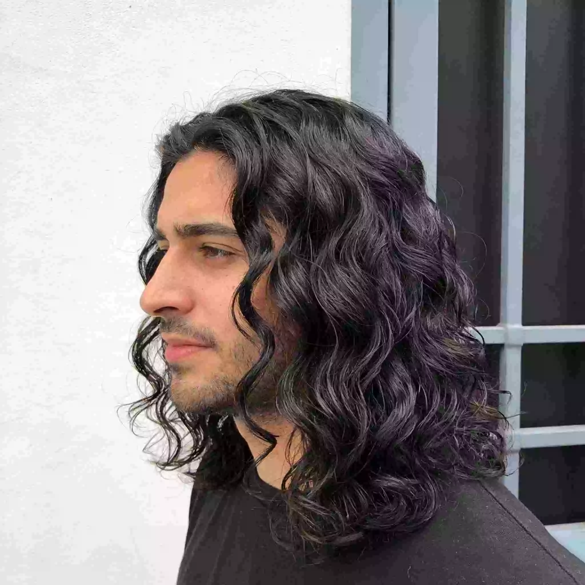 Men’s curly hair — curly long hair with long layers and controlled volume