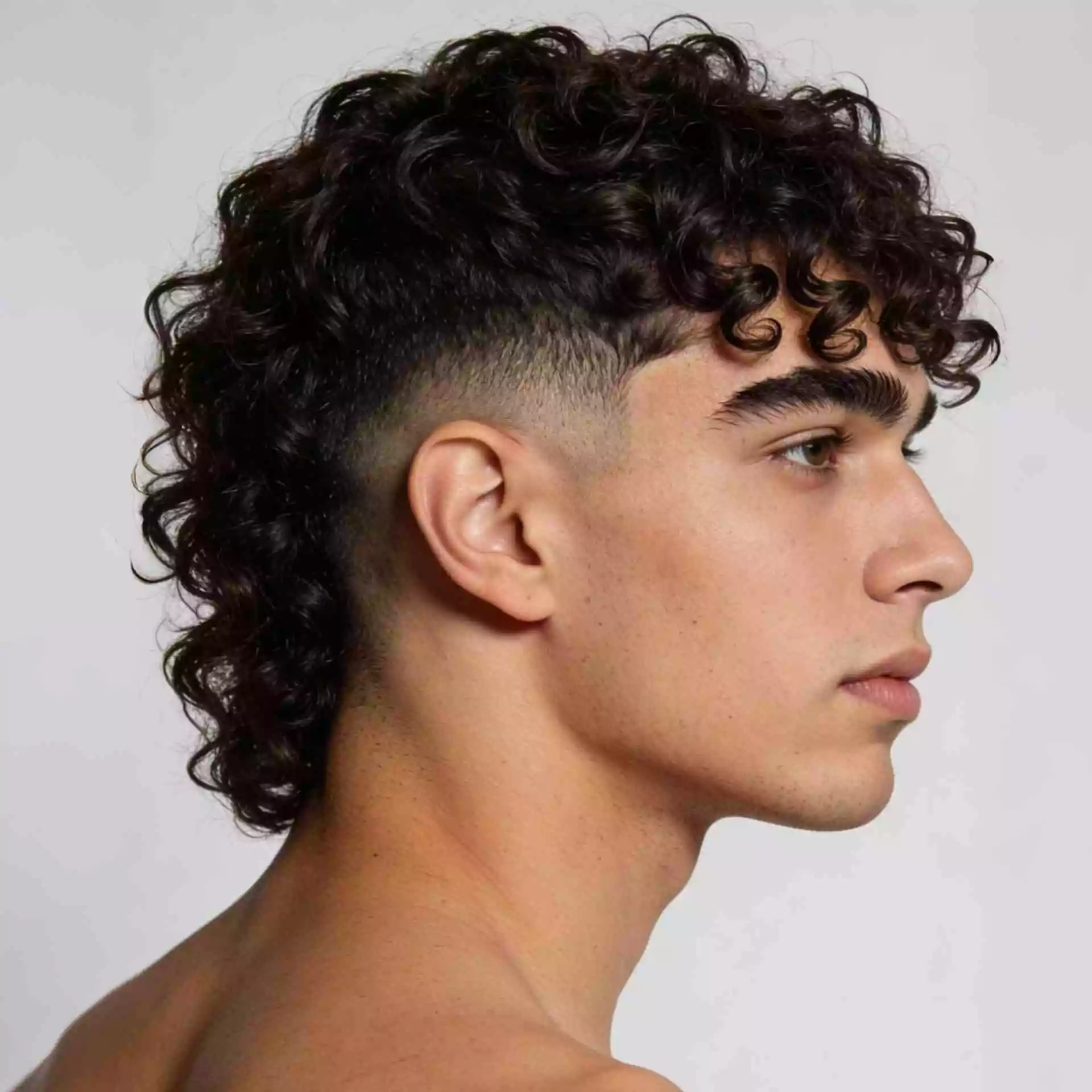 Men’s curly hair — curly fringe with clean tapered sides