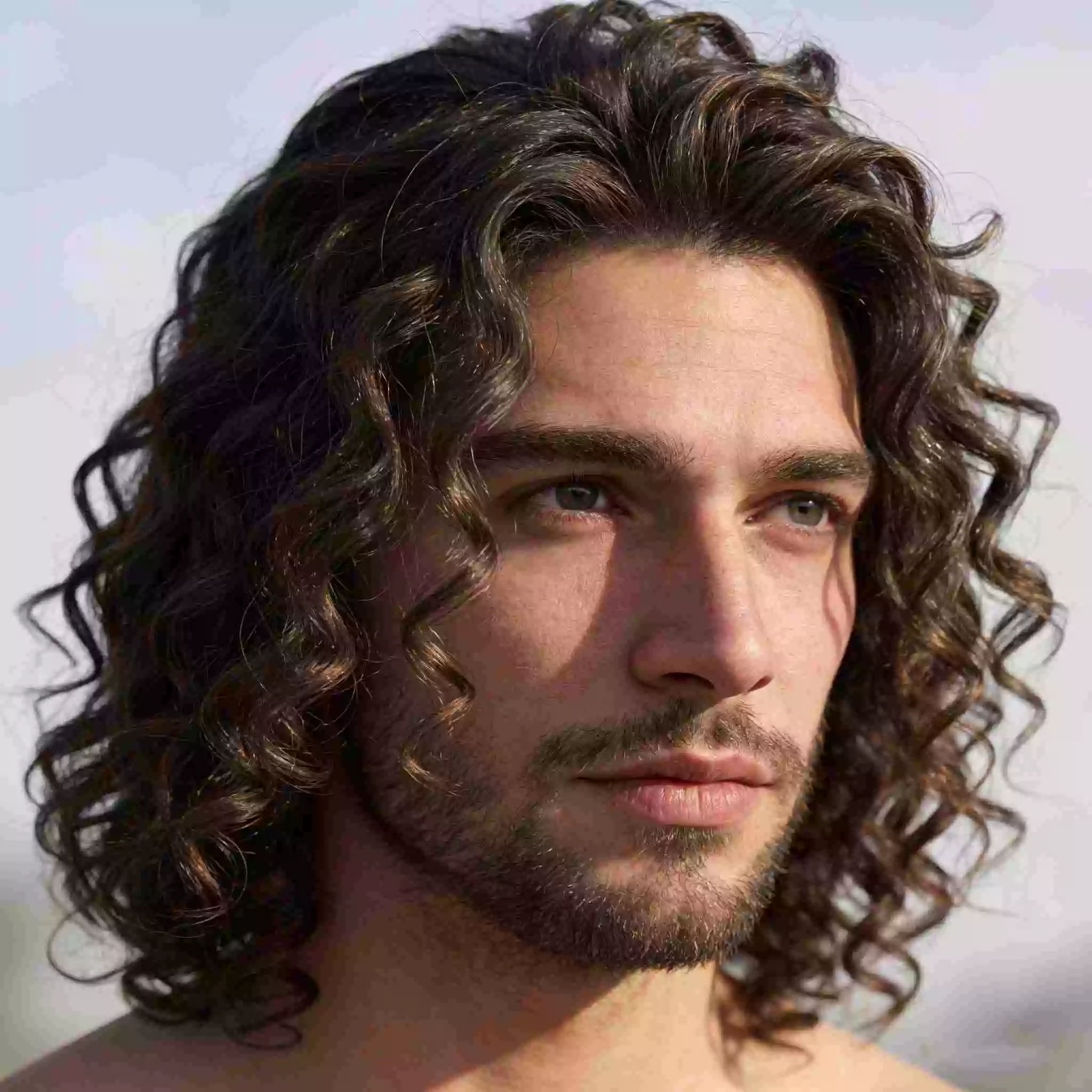 Men’s curly hair — long curly hair men with shoulder-length flow and soft face framing