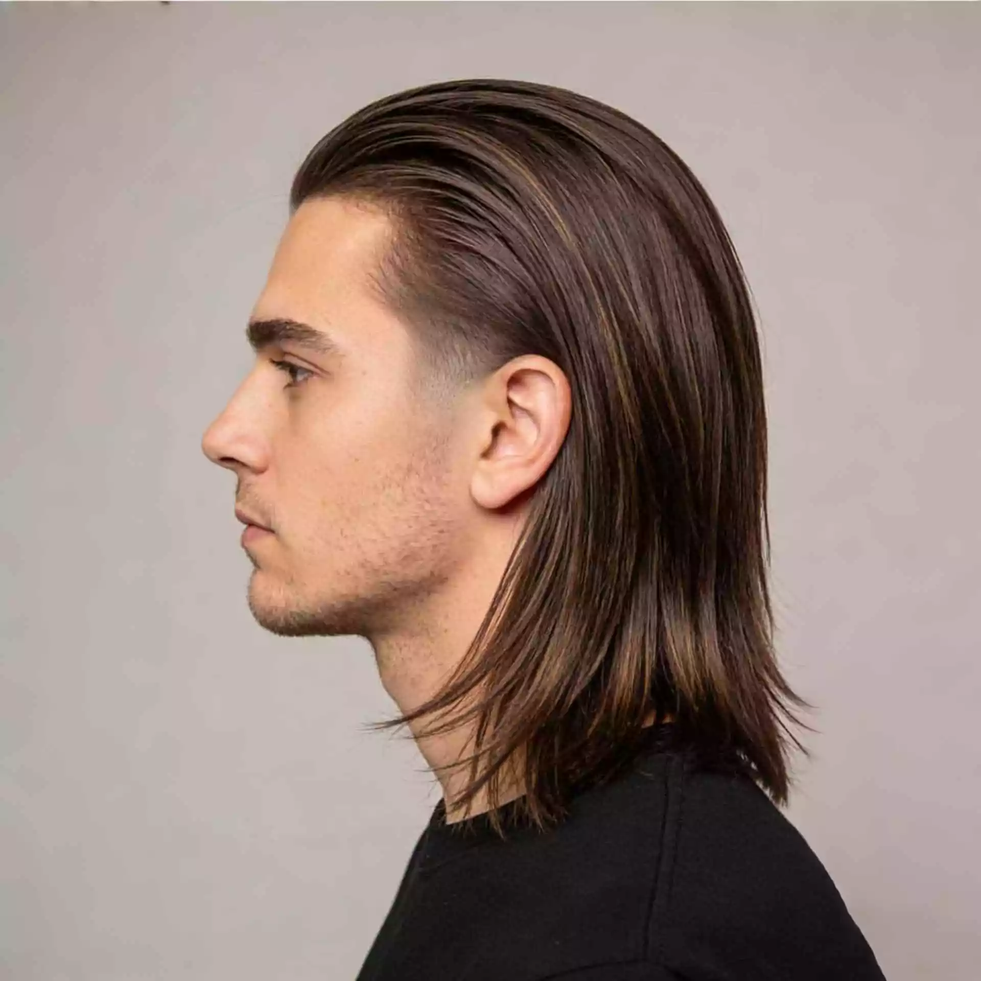 grow out low taper long hair men — straight hair in transition with tidy nape, clean ear line, and top length preserved