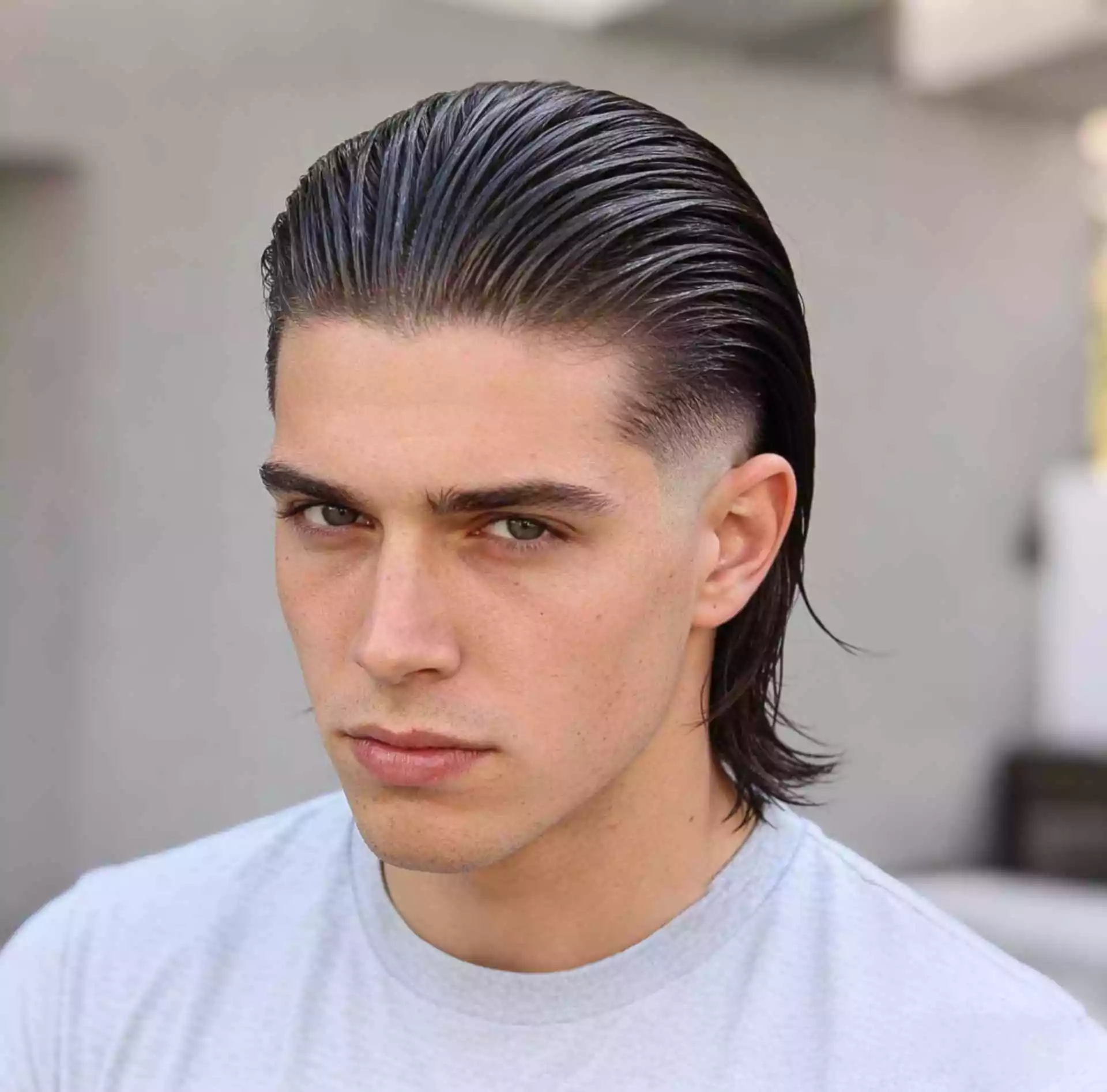 burst fade long hair slick back — brushed-back long top with rounded burst fade and clean side outline