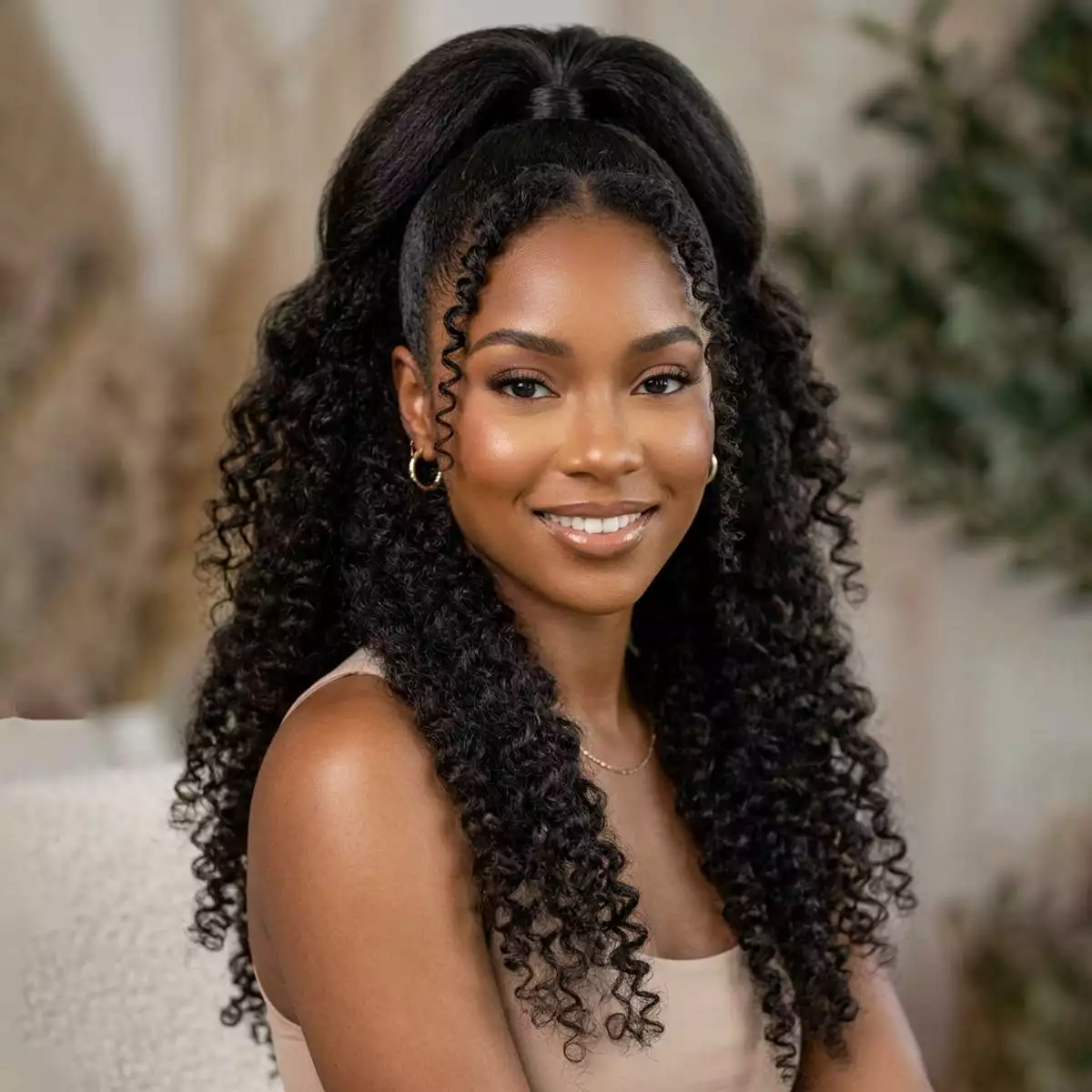 half-up half-down ponytail hairstyle for black women with lifted crown, soft lower-length texture, open face-framing shape, and polished finish