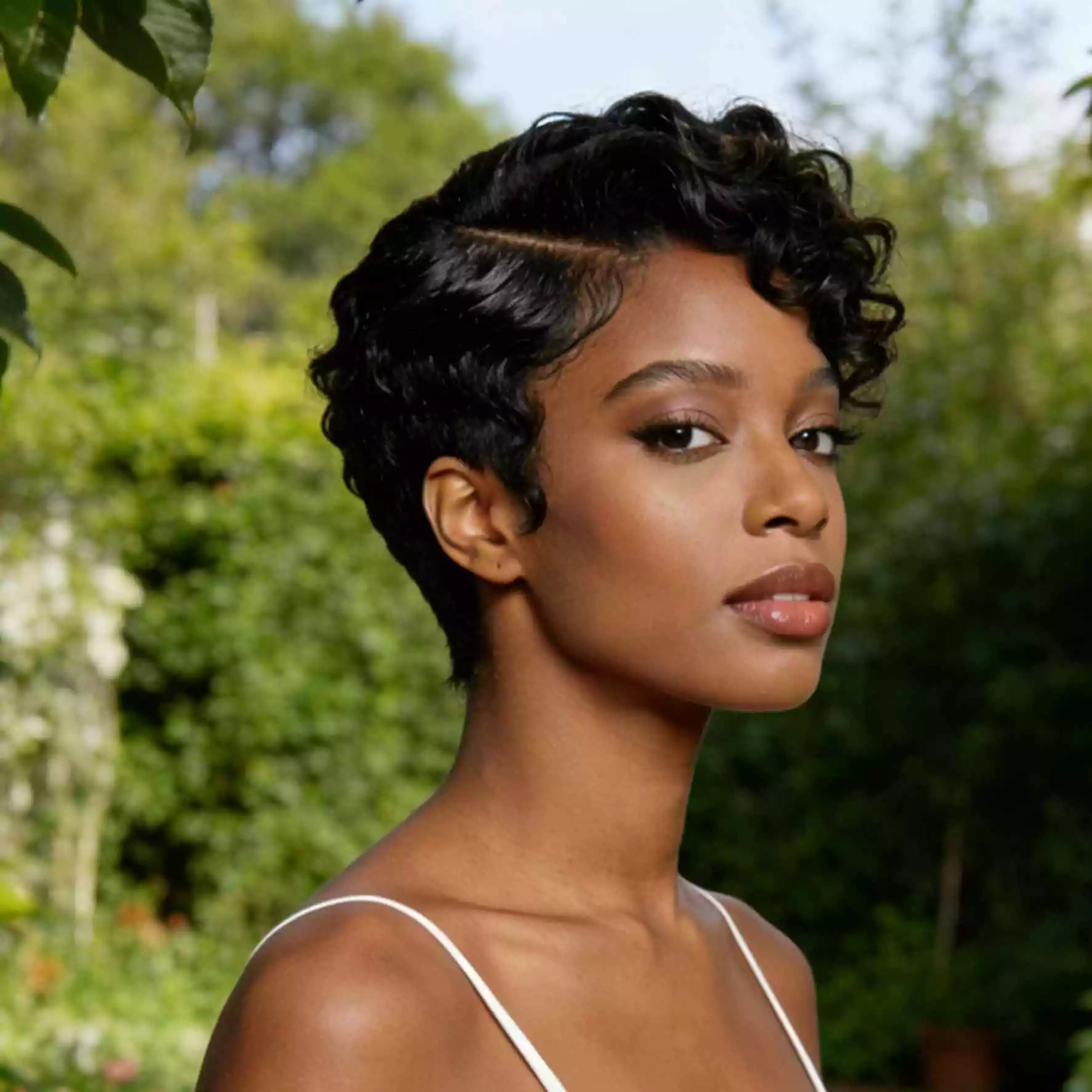 side-part sculpted short curls for black women with shaped texture and defined parting