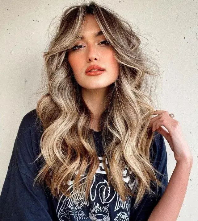 long feather layers catching the wind — the most requested 2026 haircut worldwide.
