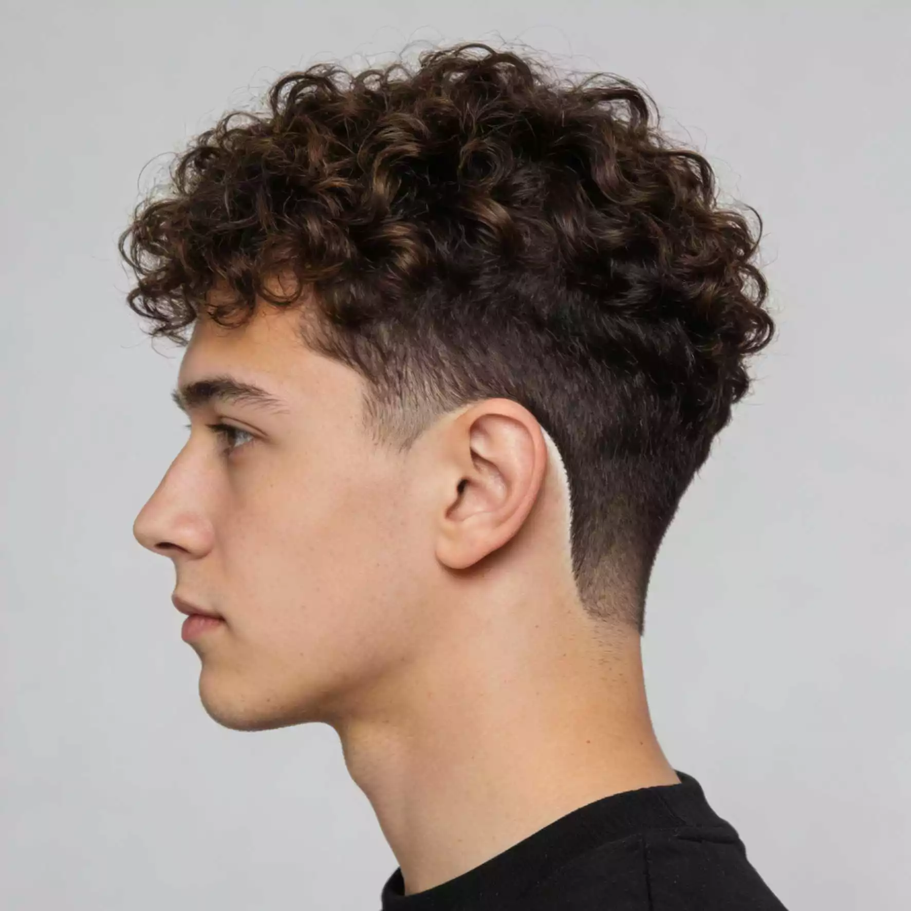 Curly top with low taper — top long sides short curly haircut for men, 2026