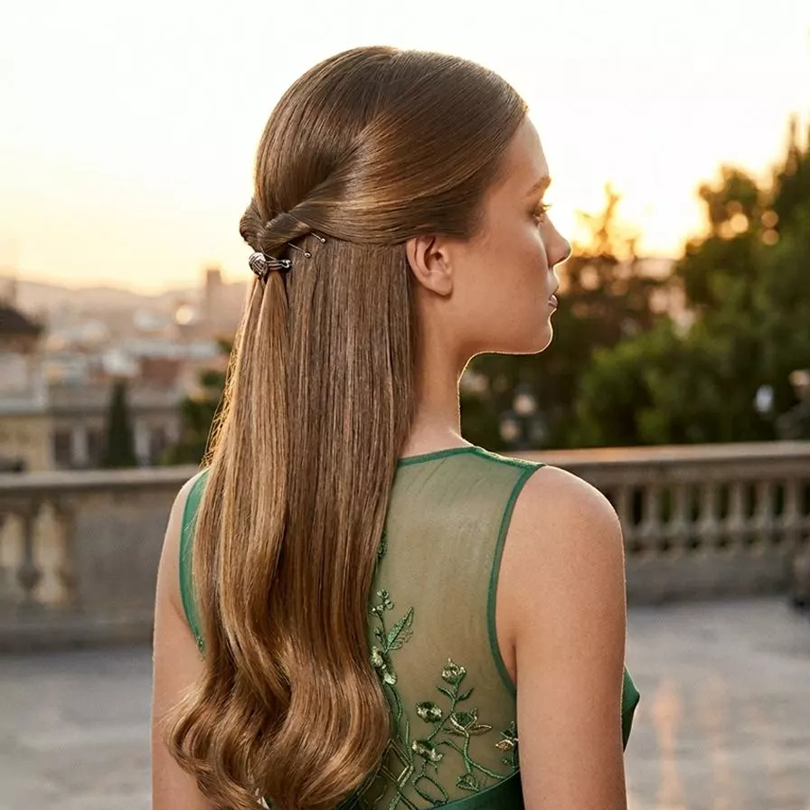 sleek modern half up half down prom hairstyle for long hair